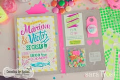 an open notebook on top of a table covered in confetti and candies