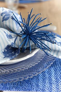 blue and white place setting with striped napkins