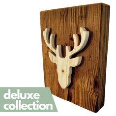 a wooden plaque with a deer's head on it