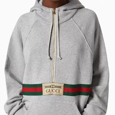 Reminiscent Of A Vintage Tracksuit, This Hooded Sweatshirt Features A Front Zip Detail And Contrast Red Piping. Emblematic House Codes, Like The Green And Red Web Stripe And The Gucci Jacquard Label, Enrich The Design. Gucci Gray Sweatshirt With Gucci Logo And Web Gray Heavy Felted Cotton Jersey Green And Red Web Stripe Gucci Jacquard Label Fixed Hood Partial Zip Front Pocket Oversized Top Fabric: 100% Cotton. Details: 44% Acrylic, 44% Wool, 12% Viscose. Application: 100% Polyester. Size L Produ Gucci Sporty Sweatshirt With Logo Detail, Gucci Sporty Sweatshirt For Fall, Gucci Cotton Sweatshirt With Logo, Fire Fashion, Gucci Hoodie, Vintage Tracksuit, Gucci Shirts, Red Web, Gucci Design