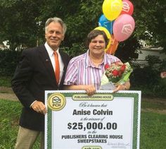 two people holding a large check for $ 25, 000