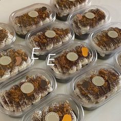 twelve plastic containers filled with desserts on top of a table