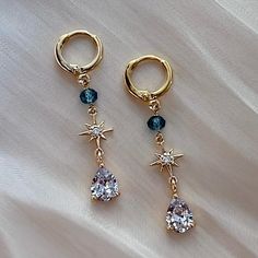 * DETAILS * - Genuine London Blue Topaz Beads - 18K Gold Plated Star Charms - CZ Teardrop Charms  - Gold Plated Over Brass Huggie Earrings 10mm  ✨Y- Necklace.  https://www.etsy.com/JinnysJewelryBySeJin/listing/1106702823/baroque-pearl-drop-y-necklace-special?utm_source=Copy&utm_medium=ListingManager&utm_campaign=Share&utm_term=so.lmsm&share_time=1634901704788 👉🏻Please note that all Jinny's Jewelry pieces are crafted by hand and one-of-a-kind, and may therefore vary slightly in size and shape. ------------------------------------------------ * CARE TIPS * ⭐️TO PREVENT TARNISH: Keep your jewellery in airtight plastic bags. It won't tarnish if it isn't exposed to air. The worst place to leave your jewellery is in a steamy bathroom. Wipe with a soft cloth after wearing. - Perfumes: Be sure a Earrings Pearl Drop, Earrings Pearl, Special Jewelry, Huggie Earrings, London Blue Topaz, London Blue, Polish Jewelry, Star Charms, Pearl Drop Earrings