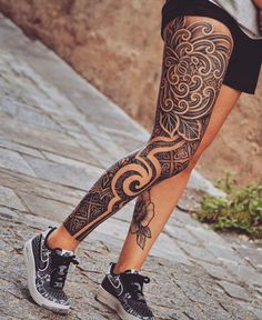 a woman's legs with tattoos on them