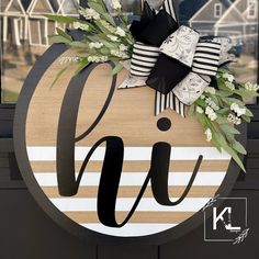 a wooden sign with flowers on it that says oj in black and white stripes