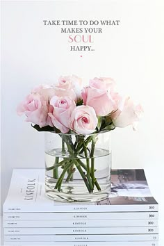 some pink roses are in a glass vase on top of two books and the words, take time to do what makes your heart happy