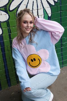 The Happy Flower Jumper! A super fun half and half bodice just to mix things up. Complete with large Pink Fleece Flower and Yellow Chenille Smiley Face for the centre. Hand sewn on with playful thick thread. Alternate coloured Sleeves!! What a great addition to your weird and wonderful Wardrobe. Bringing lots of happy happy vibes! Very 90s!  STYLING TIPS: Looks great matched with Denim Jeans and Trainers. Have the coolest hangover Sweatshirt at a Festival or chuck it on down at the beach. So man Playful Patchwork Crew Neck Top, Fun Patchwork Tops For Spring, Fun Patchwork Spring Tops, Playful Light Blue Tops For Spring, Flower Smiley Face, Flower Jumper, Oversized Jumper Dress, Flower Smiley, Face Sweating