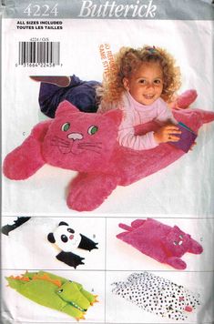 a child's stuffed animal pattern with cats and other animals on it, including an adult