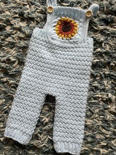 Hand crocheted overalls with gorgeous sunflower design on bib.  Made with 100% acrylic yarn. Button fastening with full length legs.  Size 0-3 months.  Pattern by BabyCrochetDesigns Crocheted Overalls, Crochet Dungarees, Crochet Overalls, Crocheted Sunflower, Crochet Sunflower, Sunflower Design, Dungarees, Hand Crochet, Acrylic Yarn