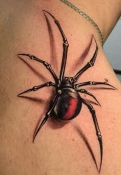 a spider tattoo on the back of a woman's shoulder