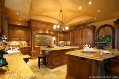 a large kitchen with wooden cabinets and marble counter tops, along with a center island