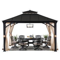 a black and white gazebo with curtains on it's sides, set up for an outdoor dining area