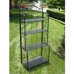 three tiered metal plant stand in the grass