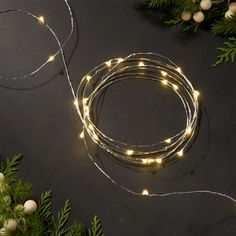 a christmas wreath with white lights and greenery