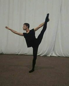 a man standing on one leg in the middle of a dance pose