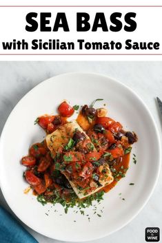 a white plate topped with sliced tomatoes and bread