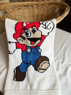 a knitted pillow with an image of mario on it