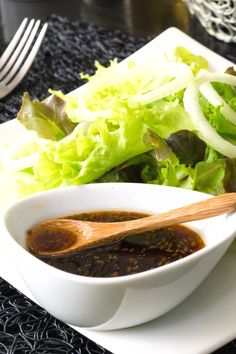 lettuce and sauce in a bowl on a plate