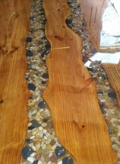 wood flooring that has been sanded down with pebbles and gravel on the ground