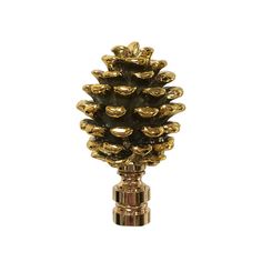 a gold pine cone is on top of a metal stand with lots of nuts in it