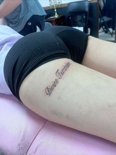 a woman laying on top of a pink chair with her arm around the back of her body