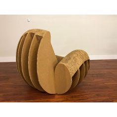 a chair made out of cardboard sitting on top of a wooden floor