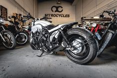 several motorcycles parked in a garage next to each other