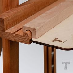 a close up of a wooden bench with a piece of wood sticking out of it