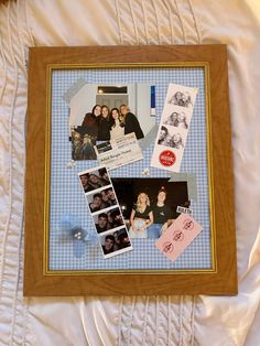 a collage of family photos is displayed in a wooden frame on a white bed