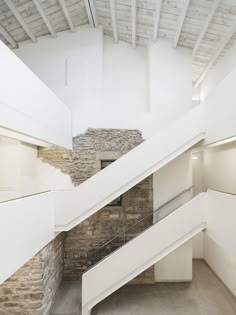 an empty room with stone walls and stairs