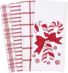 three red and white kitchen towels with candy canes on them