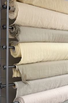 several rolled up linens are hanging on a rack