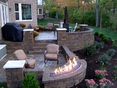 an outdoor patio with fire pit and seating area