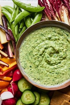 an assortment of vegetables and dip in a bowl