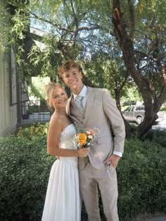 a young man and woman posing for a photo