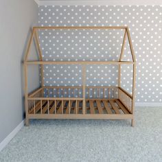 a wooden bed frame in front of a wallpapered room with stars on it