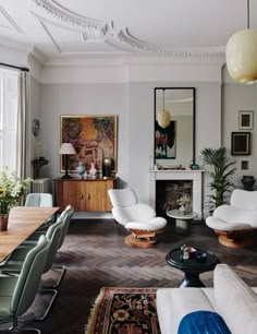 a living room filled with furniture and a fire place in the middle of a room