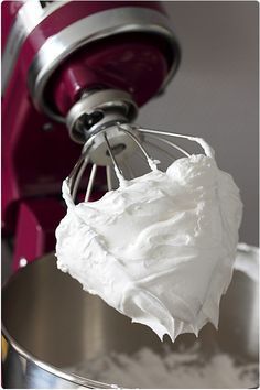 a mixer with whipped cream in it is being used to make desserts and other treats