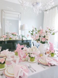 the table is set with pink and white dishes