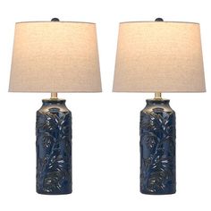 two blue vases with lamps on them