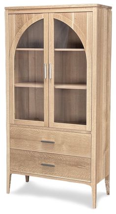 a wooden cabinet with glass doors and drawers on the bottom shelf is shown in light wood