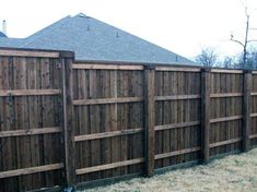 a wooden fence in front of a house