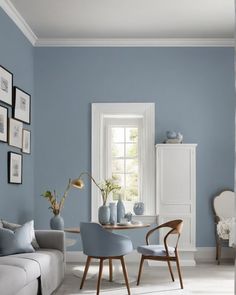 a living room with blue walls and white furniture in it's centerpieces