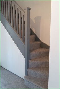 the stairs are made of carpet and have white railings on each side, along with gray carpet