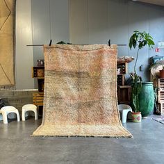 an old rug is sitting on the floor in a room with chairs and other furniture