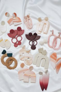 several pairs of earrings laid out on a white sheet