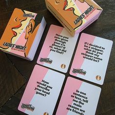 four cards that have been placed next to each other on a wooden table with the same card in front of them