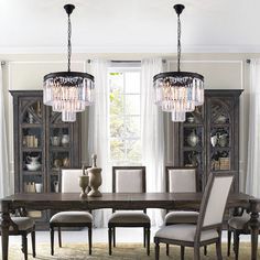 a dining room table with chairs and chandelier