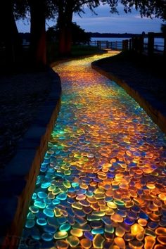 an illuminated pathway that is lit up with colored lights