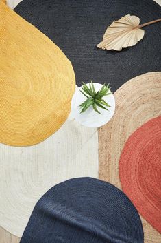 a close up of a rug with a plant on it